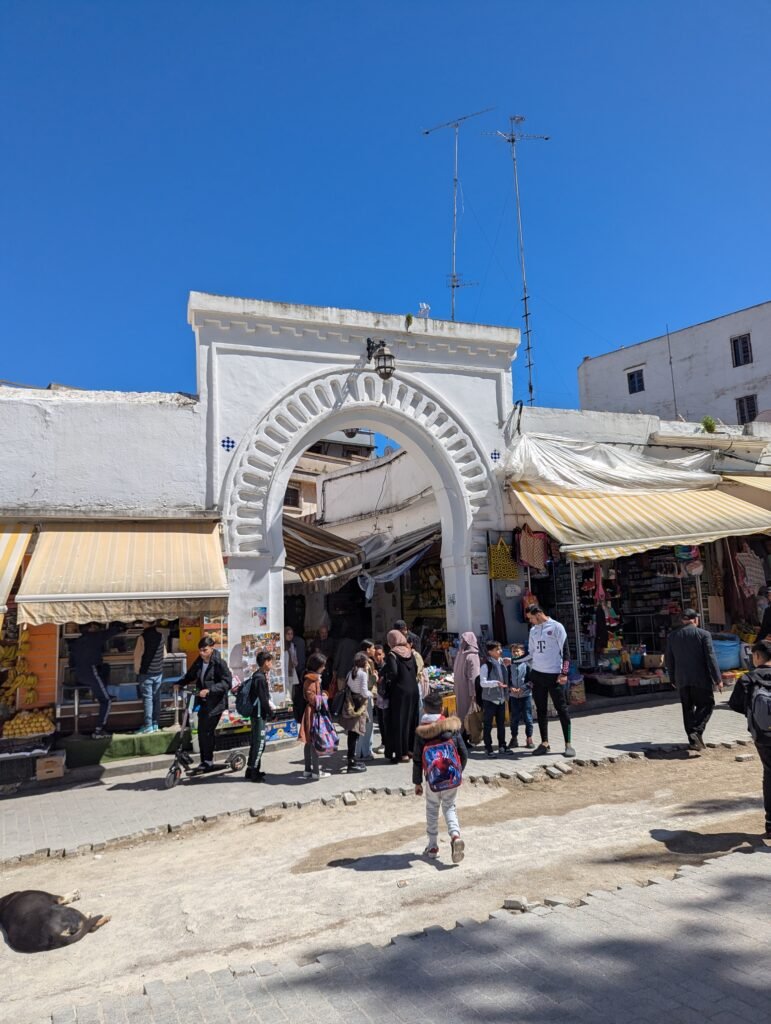 Locals in front of bab al fahs gate, the entry to tangier's grand socco in the medina