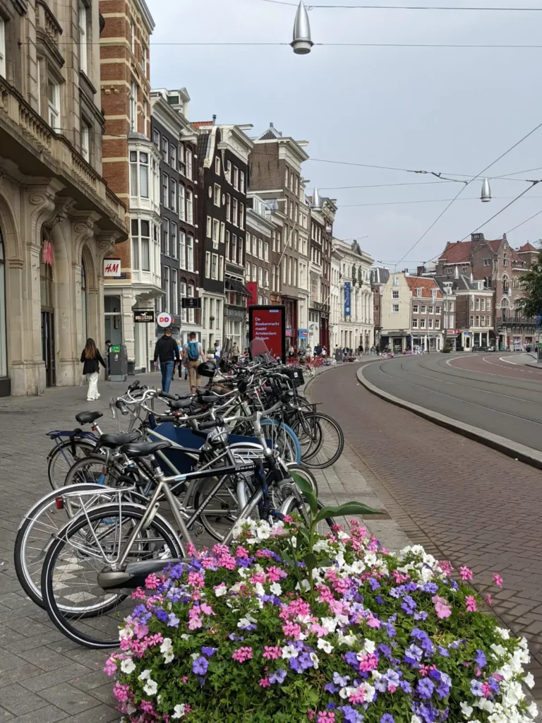 bikes parked in front of an empty red asphalt bike path in amsterdam