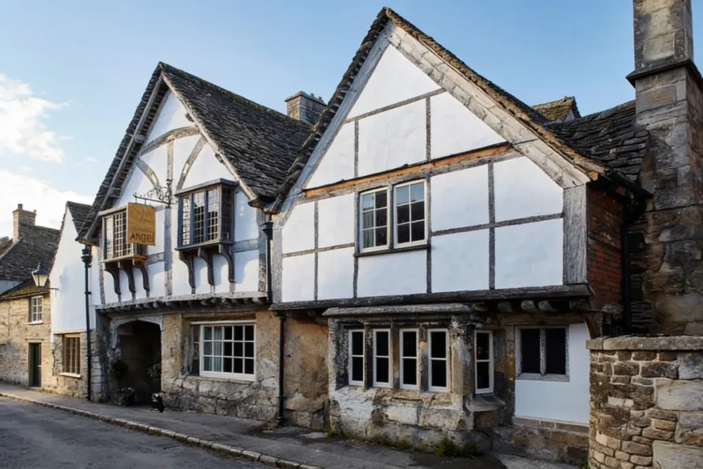 the facade of sign of the angel pub in lacock, which is the location of The Babberton Arms in Harry Potter