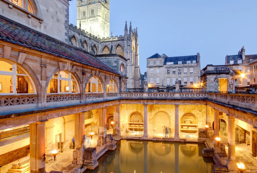 historic roman bath of bath lit up at sunset